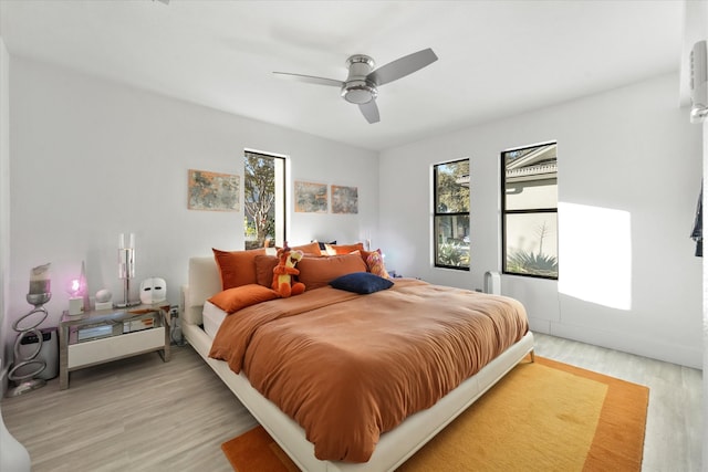 bedroom with ceiling fan and light hardwood / wood-style floors