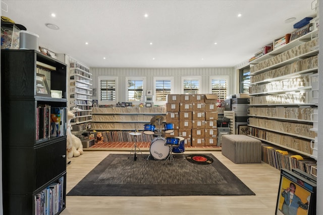 game room featuring light hardwood / wood-style flooring and a textured ceiling