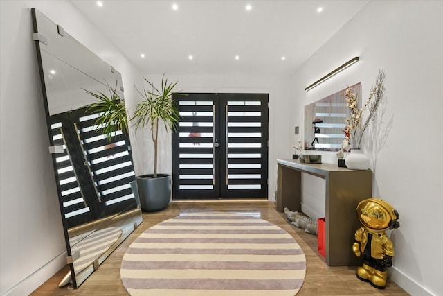 foyer entrance featuring french doors and light wood-type flooring