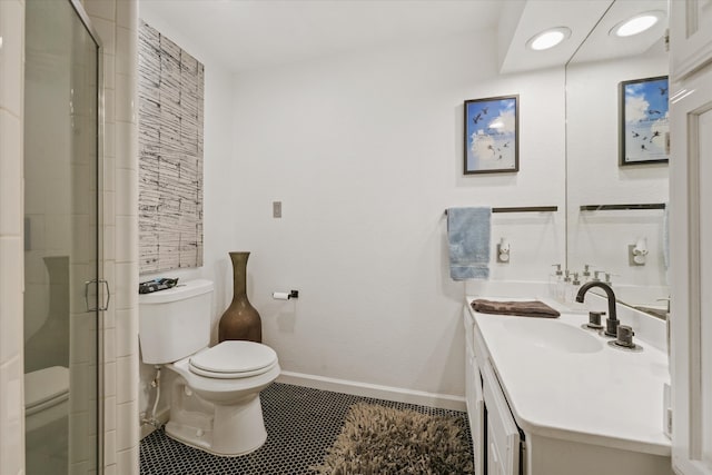 bathroom with tile patterned flooring, vanity, a shower with shower door, and toilet