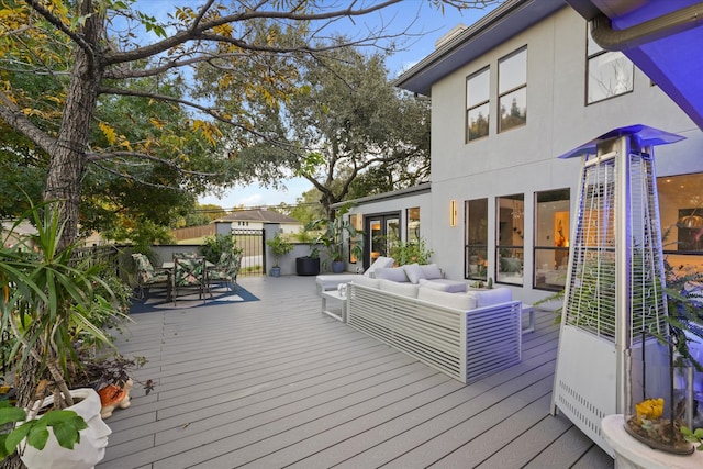 wooden terrace with an outdoor hangout area