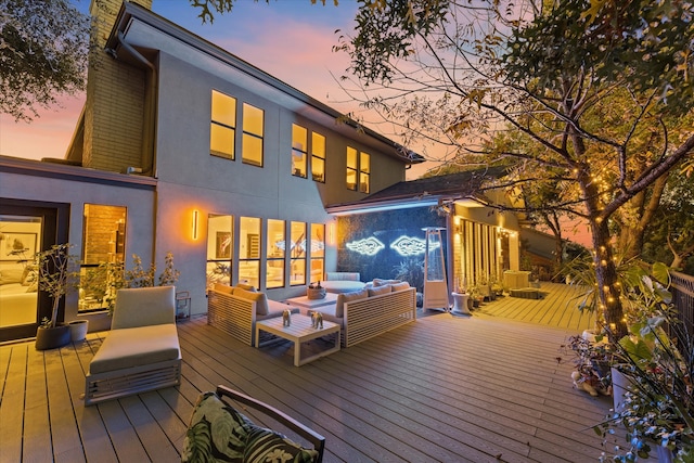 deck at dusk featuring an outdoor living space