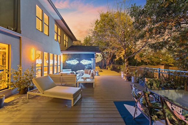 deck at dusk featuring outdoor lounge area