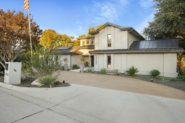 view of front of property featuring solar panels