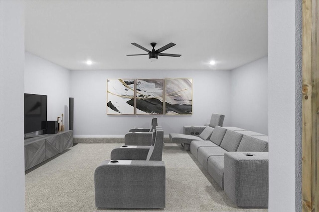 carpeted living room with ceiling fan