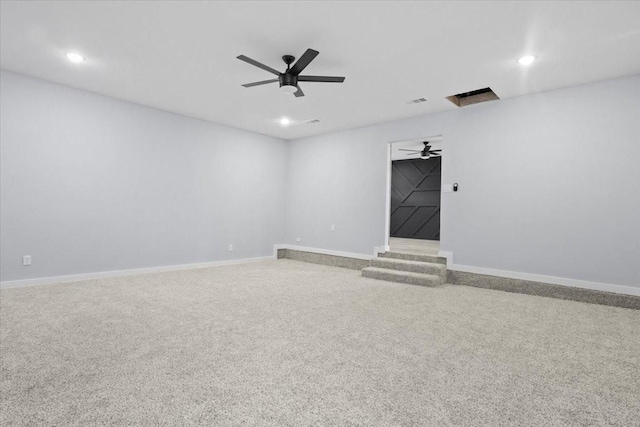 empty room featuring ceiling fan and carpet