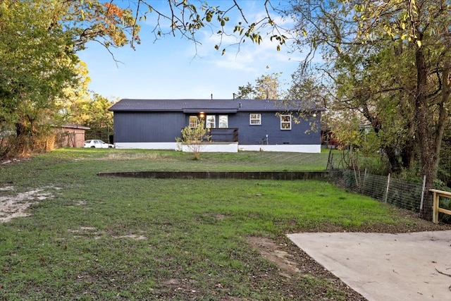 rear view of property featuring a lawn