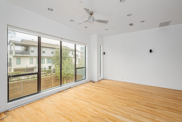 spare room with light hardwood / wood-style flooring and ceiling fan