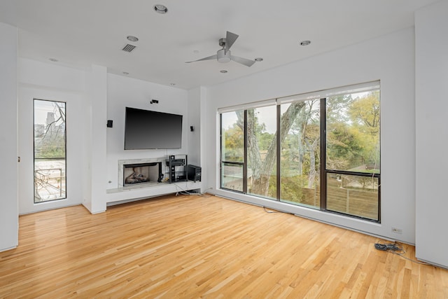 unfurnished living room with ceiling fan and light hardwood / wood-style floors