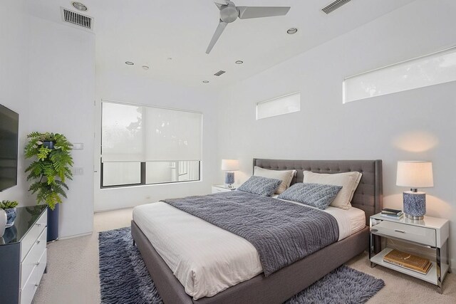 bathroom featuring tile patterned flooring, plenty of natural light, radiator, and tiled bath