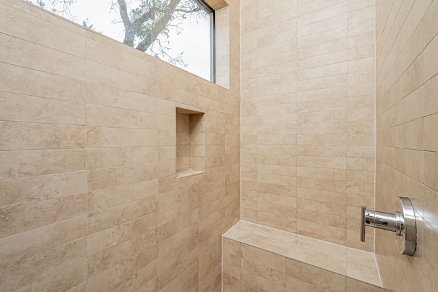 bathroom with tiled shower