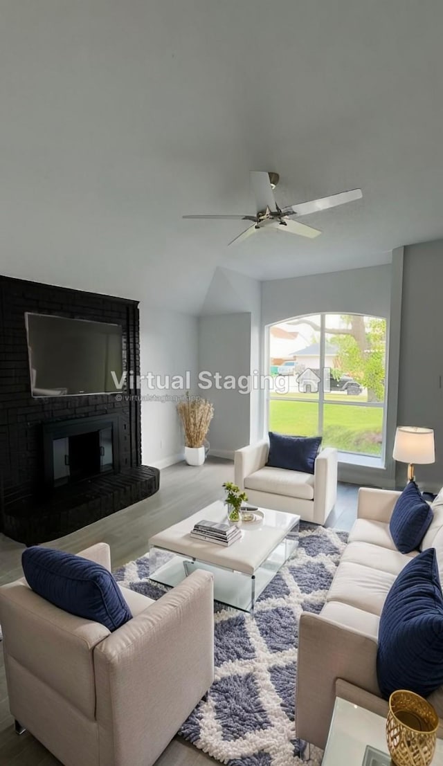 living room with wood-type flooring and ceiling fan