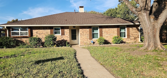 ranch-style home with a front lawn