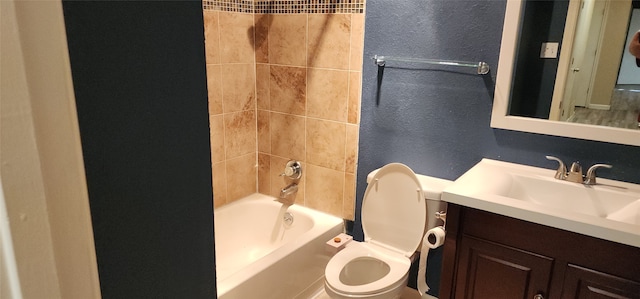 full bathroom featuring vanity, toilet, and tiled shower / bath