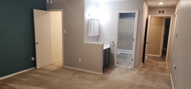 full bathroom featuring vanity, tiled shower / bath combo, and toilet