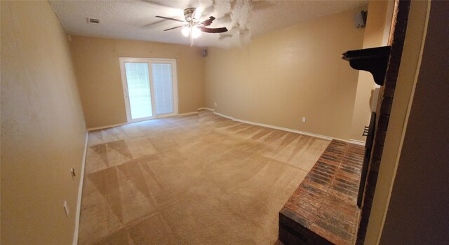 carpeted spare room with ceiling fan and a textured ceiling