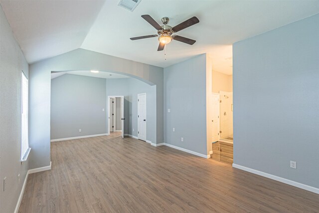 unfurnished room with ceiling fan, plenty of natural light, wood-type flooring, and lofted ceiling