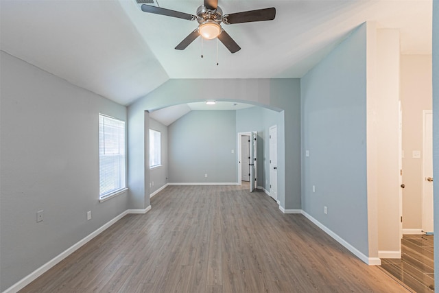 unfurnished living room with ceiling fan, hardwood / wood-style floors, and lofted ceiling