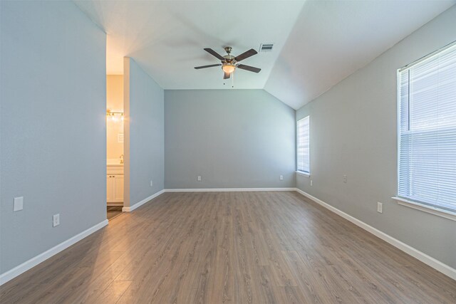 interior space with ceiling fan, plenty of natural light, and hardwood / wood-style flooring