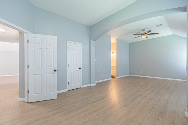 interior space with ceiling fan, lofted ceiling, and light wood-type flooring