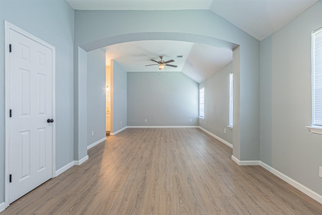 interior space featuring ceiling fan, light hardwood / wood-style floors, and lofted ceiling