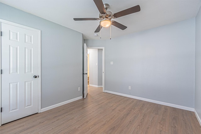 unfurnished bedroom with ceiling fan and light wood-type flooring