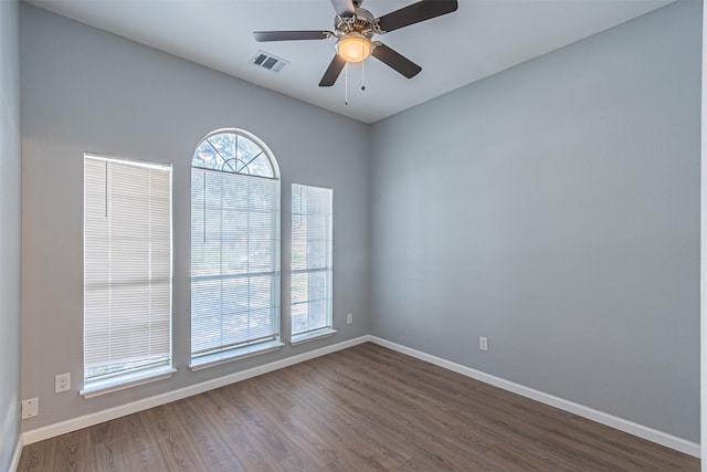 empty room with ceiling fan and dark wood-type flooring