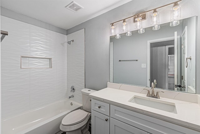 full bathroom featuring vanity, toilet, and tiled shower / bath