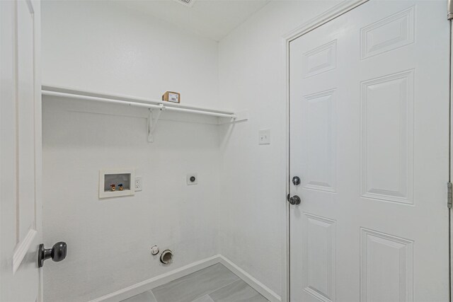 washroom with electric dryer hookup, gas dryer hookup, tile patterned flooring, and washer hookup