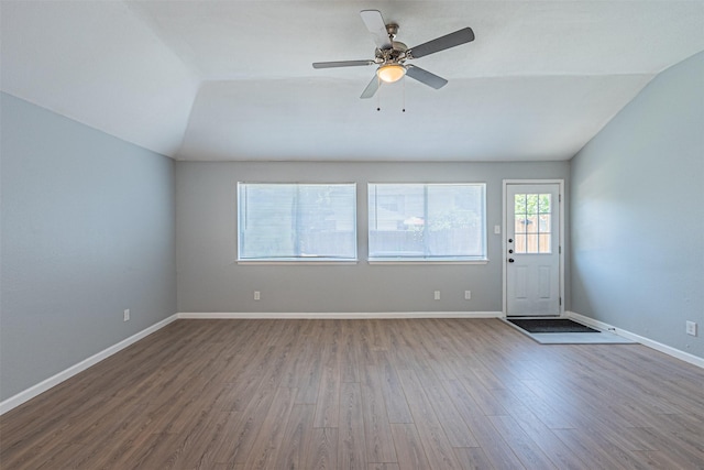 interior space featuring ceiling fan, wood-type flooring, and vaulted ceiling