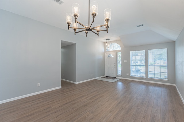 foyer featuring lofted ceiling, dark hardwood / wood-style floors, and a notable chandelier