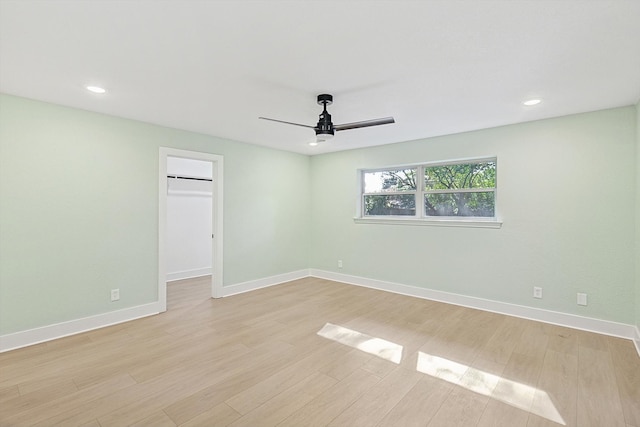 spare room featuring ceiling fan and light wood-type flooring