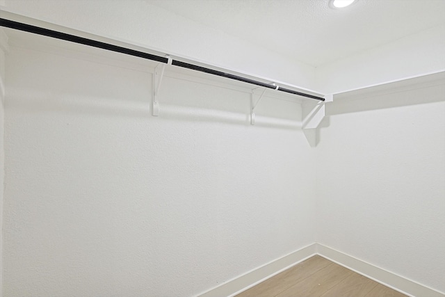 walk in closet featuring hardwood / wood-style flooring