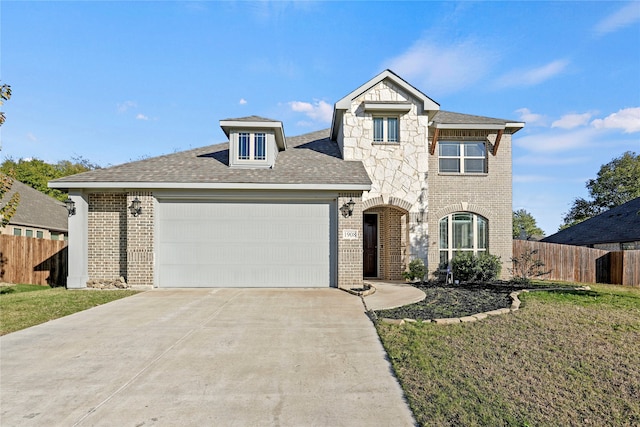 view of front of property featuring a front yard and a garage