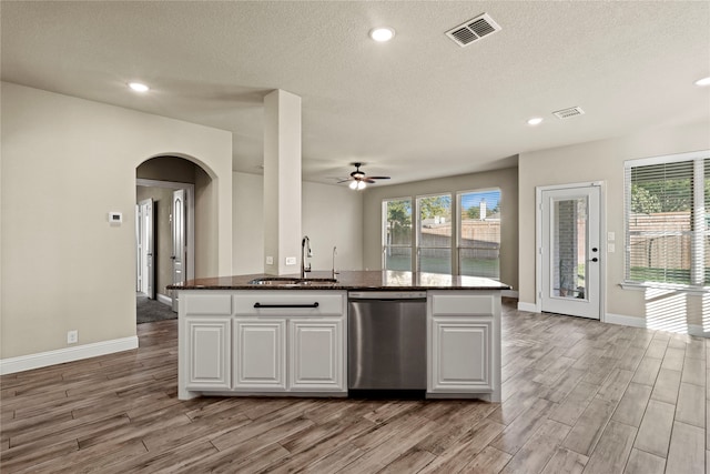 kitchen with sink, stainless steel dishwasher, ceiling fan, light hardwood / wood-style floors, and white cabinetry