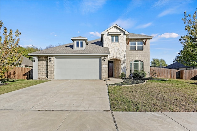 view of front of home with a front lawn and a garage