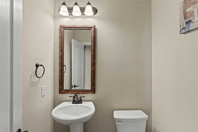 bathroom featuring sink and toilet