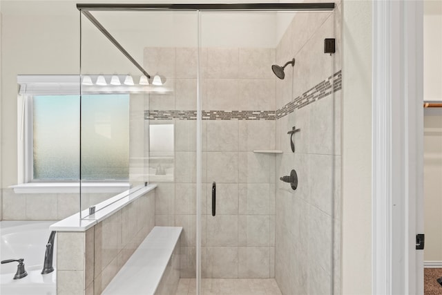 bathroom with separate shower and tub