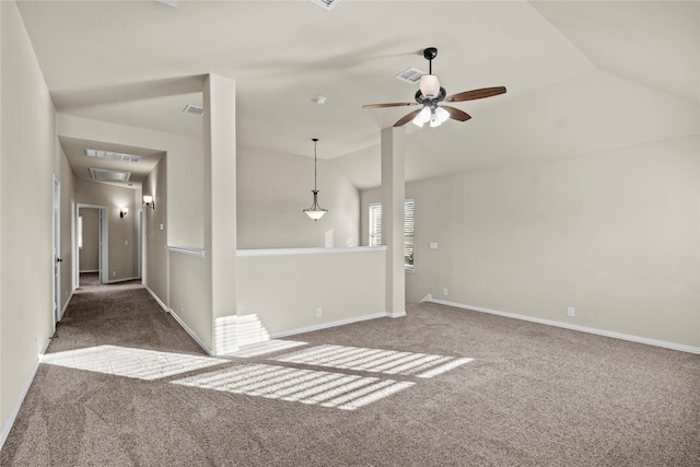 carpeted spare room featuring ceiling fan and vaulted ceiling