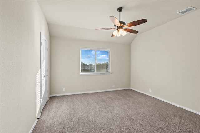 unfurnished room with carpet flooring, vaulted ceiling, and ceiling fan