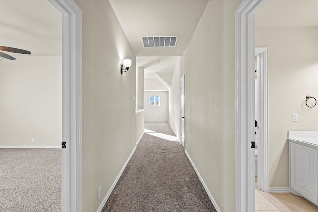 hall with light colored carpet