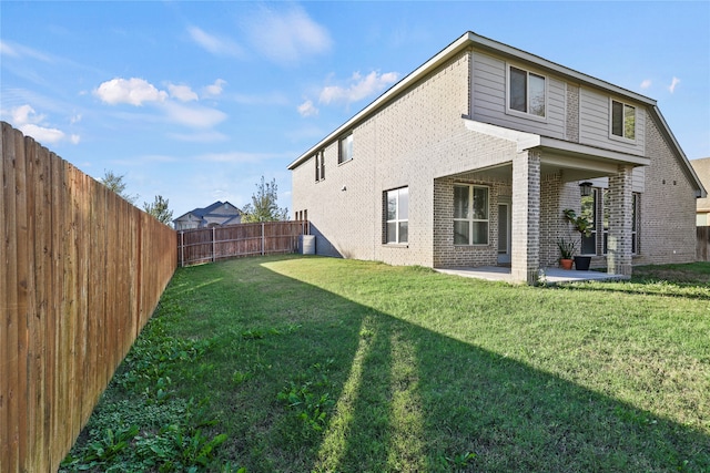 back of house with a patio, cooling unit, and a lawn