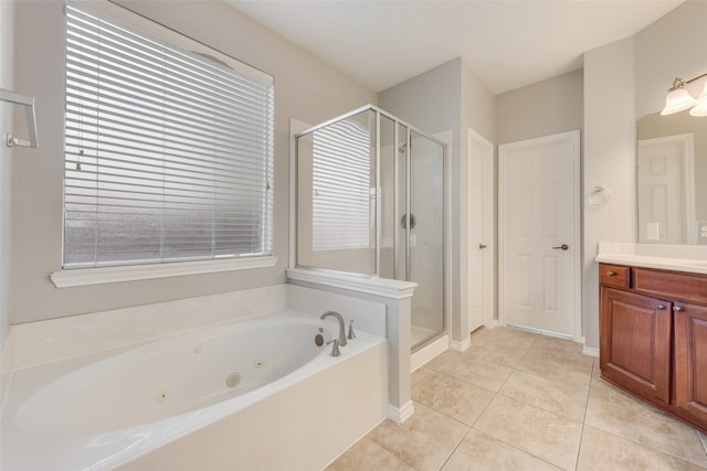 bathroom featuring plus walk in shower, vanity, and tile patterned floors