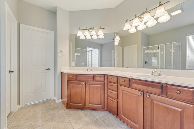 bathroom featuring an enclosed shower, vanity, a wealth of natural light, and tile patterned flooring