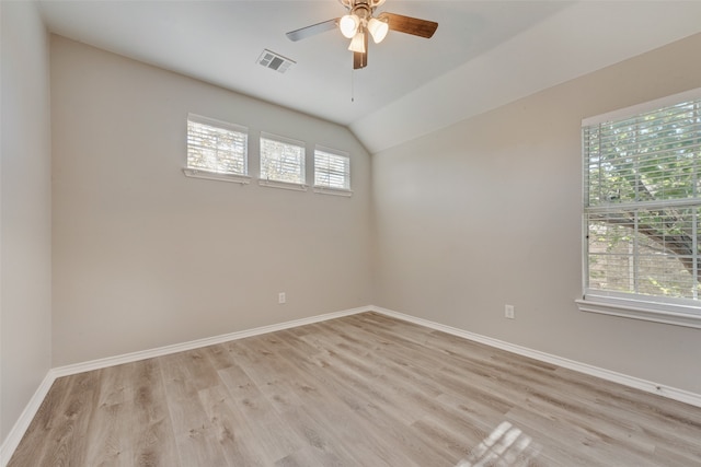 unfurnished room featuring a wealth of natural light, ceiling fan, light hardwood / wood-style floors, and lofted ceiling