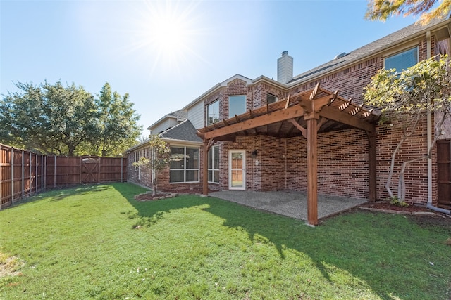 rear view of house with a patio area and a yard