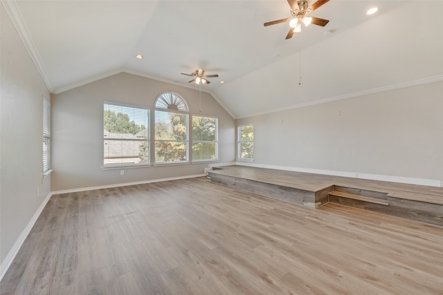 unfurnished room with ceiling fan, lofted ceiling, crown molding, and light hardwood / wood-style flooring