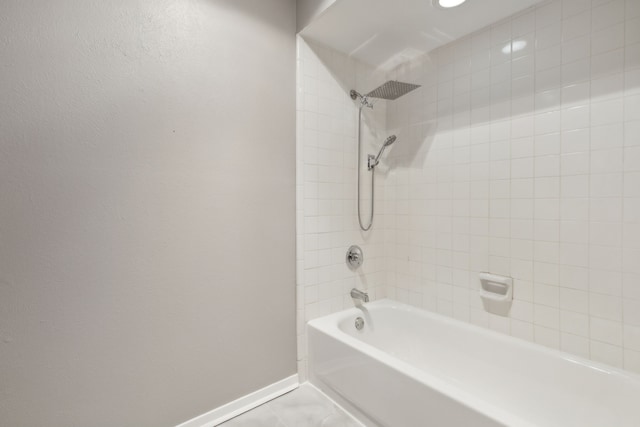 bathroom with tile patterned floors and tiled shower / bath combo