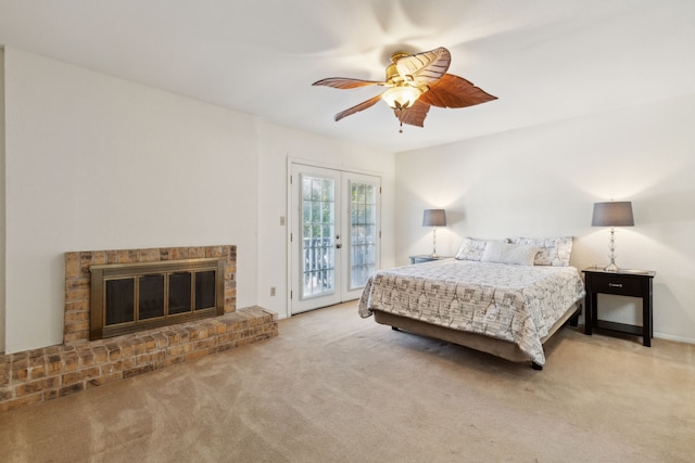 bedroom featuring french doors, a brick fireplace, ceiling fan, access to exterior, and light colored carpet