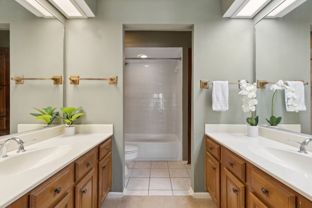 full bathroom with toilet, vanity, tile patterned floors, and tiled shower / bath